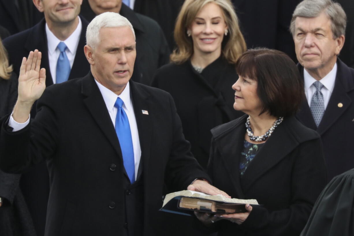 Karen Pence holds a Bible as her husband, Vice President Mike Pence, is sworn in during the 58th Presidential Inauguration on Jan. 20, 2017 at the U.S. Capitol in Washington.