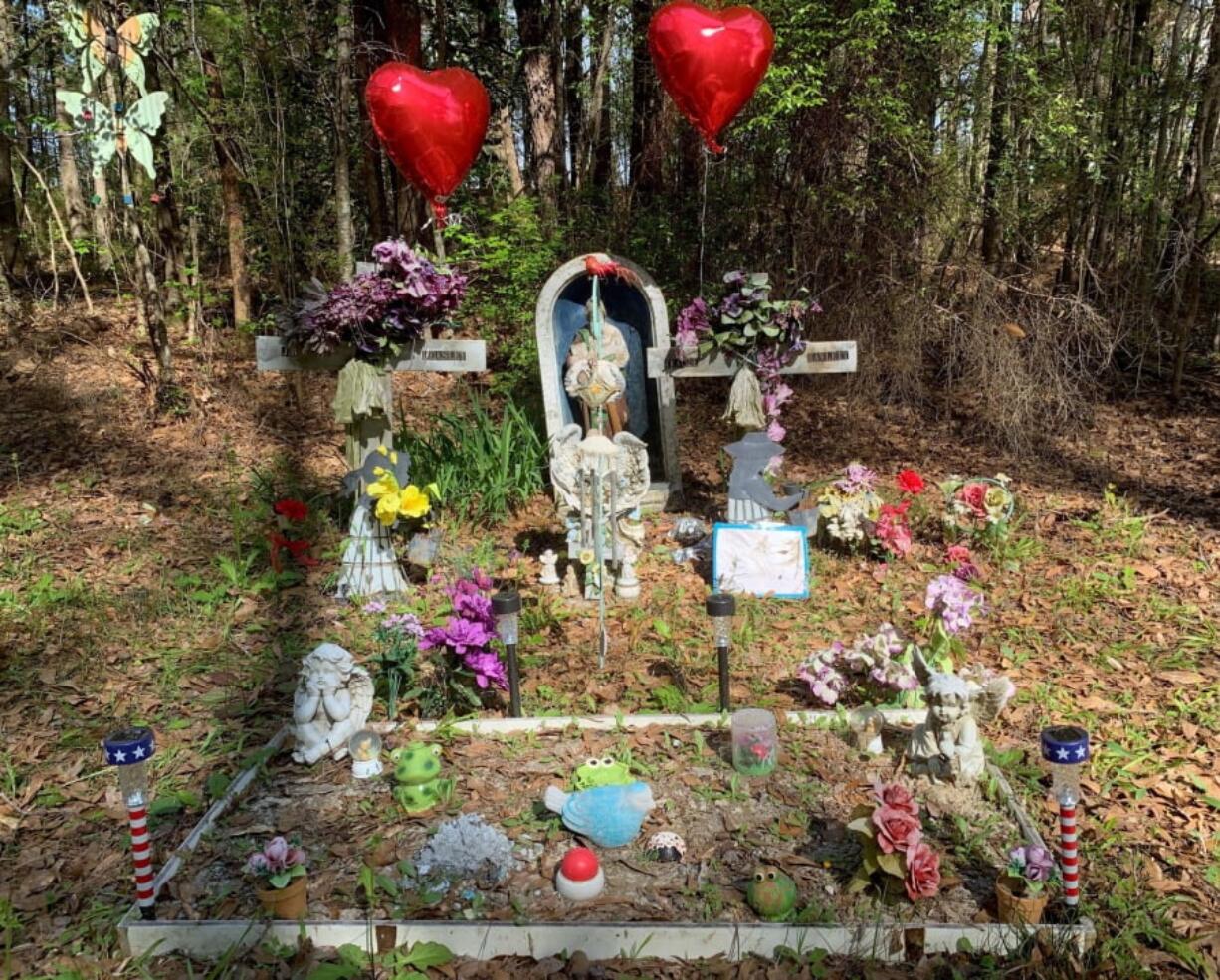 A memorial to two Alabama teenagers killed in 1999 stands beside a road at Ozark, Ala., on Tuesday, March 19, 2019. Coley McCraney, 45, of Dothan was arrested on capital murder charges in the deaths of Tracie Hawlett and J.B. Beasley, both 17. Their bodies were found in a car trunk at the spot of the memorial. Both had been shot in the head.