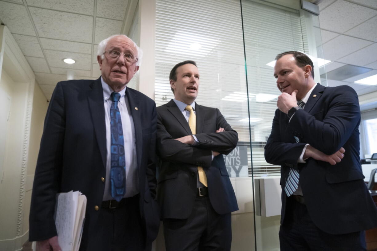 From left, Sen. Bernie Sanders, I-Vt., Sen. Chris Murphy, D-Conn., and Sen. Mike Lee, R-Utah, meet before holding a news conference on the Senate vote on ending U.S. support for the Saudi Arabian-led coalition fighting in Yemen, at the Capitol in Washington, Wednesday, March 13, 2019. (AP Photo/J.