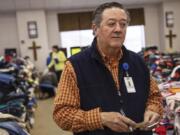 In this Wednesday, March 6, 2019 photo, Rusty Sowell, pastor at Providence Baptist Church, speaks to volunteers organizing donations at the church in Beauregard, Ala. Dealing with the dead became a huge task in a rural Alabama community where nearly two dozen people died in a tornado outbreak. The county coroner, Bill Harris, set up a temporary command post and performed post-mortem exams. He and Sowell then held 17 separate meetings with relatives of the 23 people who died.