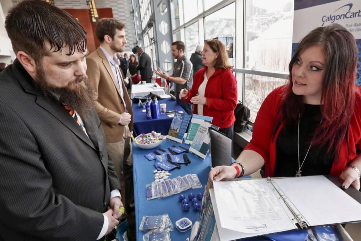 In this Thursday, March 7, 2019, photo visitors to the Pittsburgh veterans job fair meet with recruiters at Heinz Field in Pittsburgh. On Friday, March 8, the U.S. government issues the February jobs report, which will reveal the latest unemployment rate and number of jobs U.S. employers added.