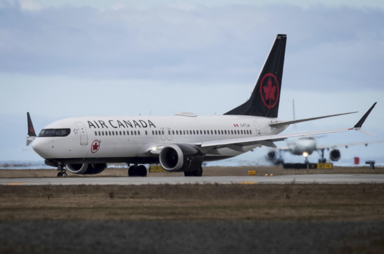 An Air Canada Boeing 737 MAX 8 aircraft departing for Calgary taxis to a runway at Vancouver International Airport in Richmond, British Columbia, on Tuesday.