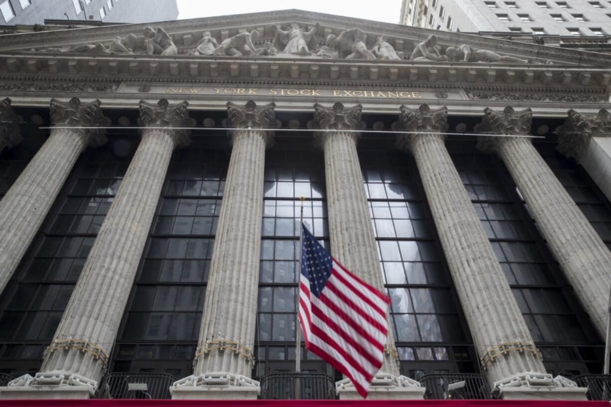 FILE- In this Nov. 20, 2018, file photo an American flag flies outside New York Stock Exchange. Stocks are opening broadly higher on Wall Street following reports that the U.S. and China are getting closer to a deal on trade. Technology stocks, industrial and internet companies were among the biggest gainers in early trading Monday, March 4, 2019.