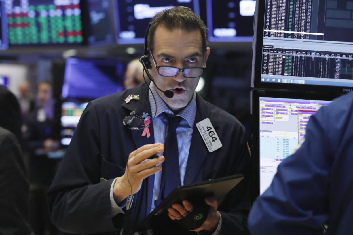 FILE- In this March 13, 2019, file photo Gregory Rowe works on the floor of the New York Stock Exchange. The U.S. stock market opens at 9:30 a.m. EDT on Tuesday, March 19.