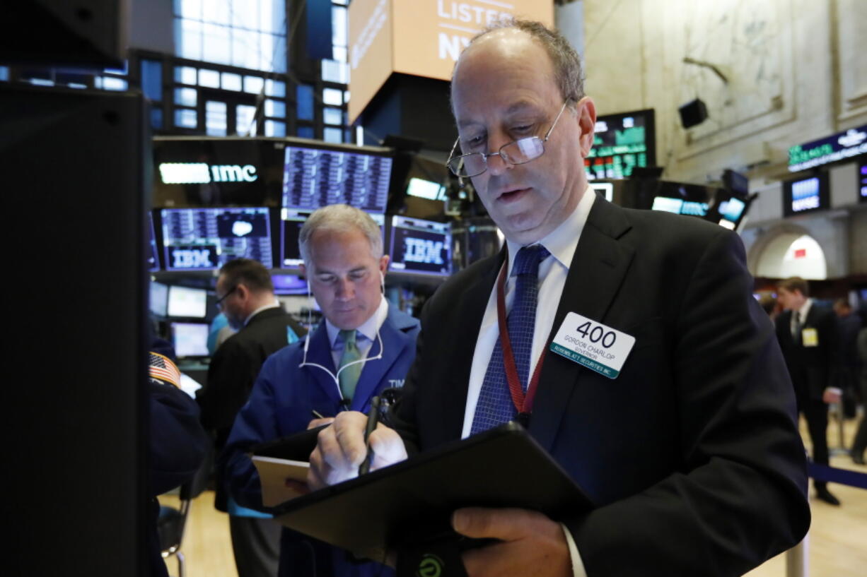 Gordon Charlop, right, works on the floor of the New York Stock Exchange. The U.S. stock market opens at 9:30 a.m. EDT on Tuesday, March 25.