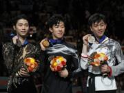 From left, Japan’s Yuzuru Hanyu, Nathan Chen from the U.S. and Vincent Zhou from the U.S. display their silver, gold and bronze medals respectively during the men’s free skating routine during the ISU World Figure Skating Championships at Saitama Super Arena in Saitama, north of Tokyo, Saturday, March 23, 2019.