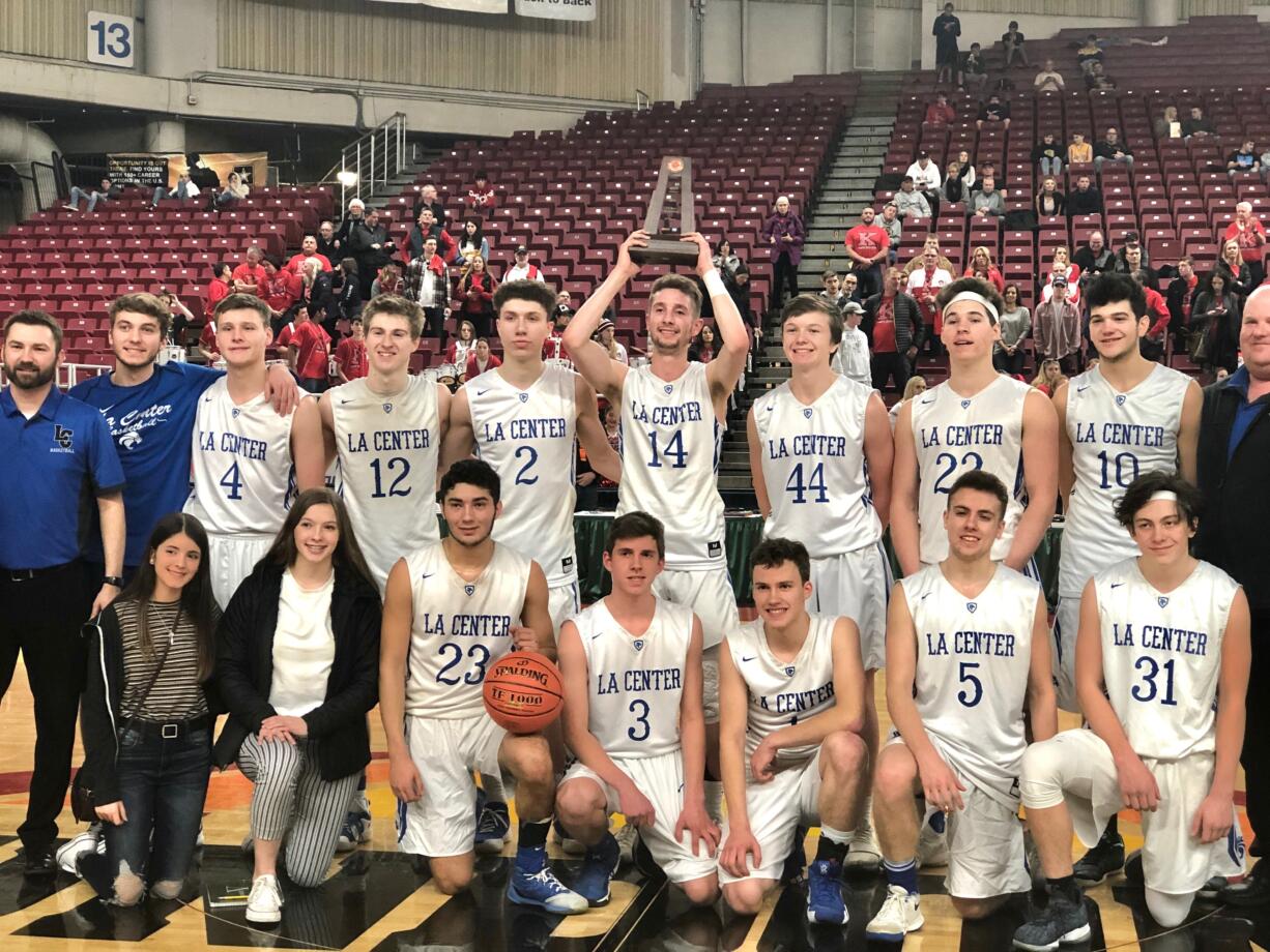 The La Center boys basketball team receives the fifth-place trophy at the 1A state basketball tournament on Saturday in Yakima.