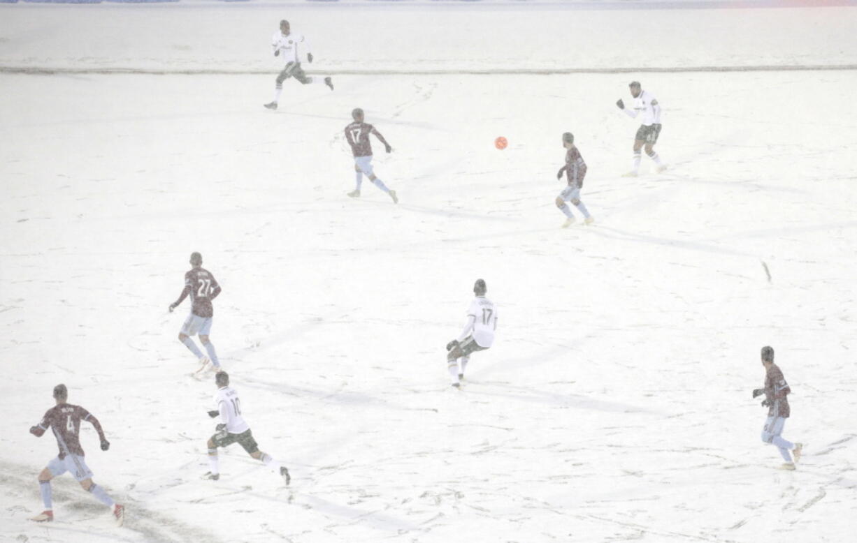 The Colorado Rapids play the Portland Timbers on a snow-covered pitch during the second half of an MLS soccer game Saturday, March. 2, 2019 in Commerce City, Colo.