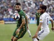 Portland Timbers midfielder Diego Valeri, left, controls the ball next to Los Angeles Galaxy midfielder Jonathan dos Santos, right, during the first half of an MLS soccer match Sunday, March 31, 2019, in Carson, Calif.