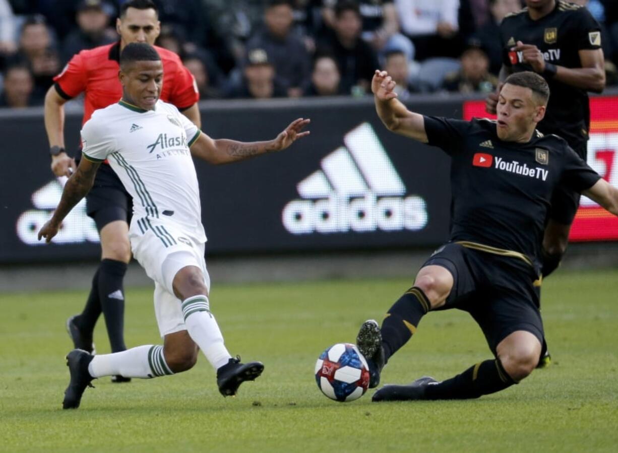 Portland Timbers forward Andy Polo, left, of Peru, and Los Angeles FC forward Christian Ramirez, vie for the ball in the first half of an MLS soccer match in Los Angeles, Sunday, March 10, 2019. (AP Photo/Ringo H.W.