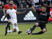 Portland Timbers forward Andy Polo, left, of Peru, and Los Angeles FC forward Christian Ramirez, vie for the ball in the first half of an MLS soccer match in Los Angeles, Sunday, March 10, 2019. (AP Photo/Ringo H.W.