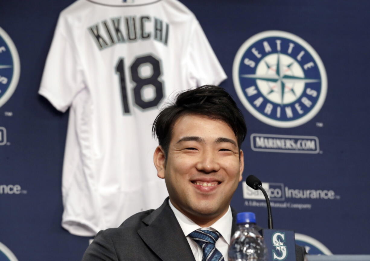 FILE - In this Jan. 3, 2019, file photo, Seattle Mariners pitcher Yusei Kikuchi smiles at a news conference following his signing with the baseball team in Seattle. Kikuchi was determined from the time he was 15 years old to be the next great Japanese import to dazzle American fans and befuddle major league hitters. That dream is now the reality for the newest starting pitcher for the Mariners.