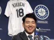 FILE - In this Jan. 3, 2019, file photo, Seattle Mariners pitcher Yusei Kikuchi smiles at a news conference following his signing with the baseball team in Seattle. Kikuchi was determined from the time he was 15 years old to be the next great Japanese import to dazzle American fans and befuddle major league hitters. That dream is now the reality for the newest starting pitcher for the Mariners.