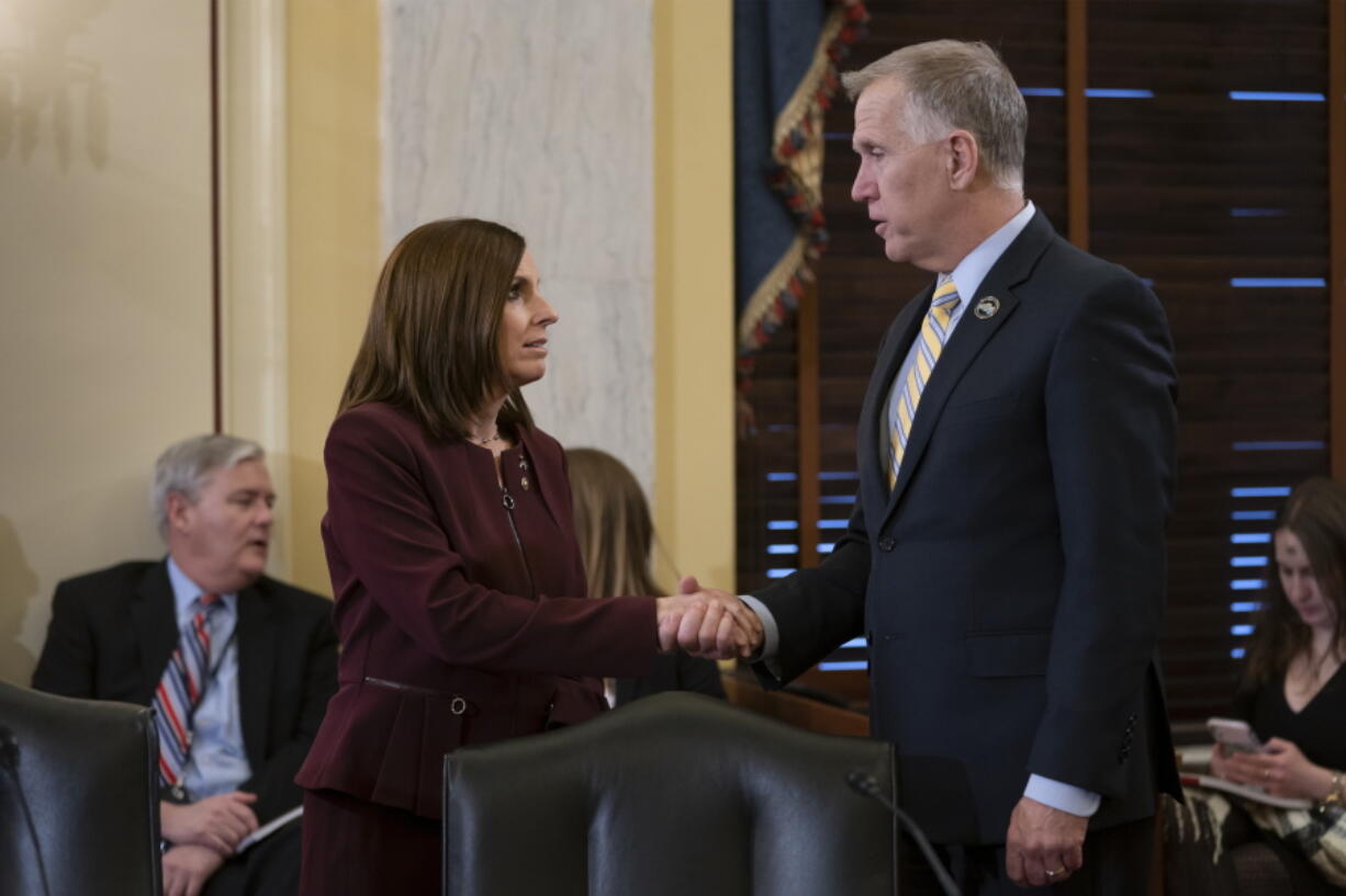 Sen. Martha McSally, R-Ariz., left, is greeted by Sen. Thom Tillis, R-N.C., chairman of the Senate Armed Services Subcommittee on Personnel, as she prepares to testify about her experience with sexual assault while serving as a colonel in the Air Force, on Capitol Hill in Washington, Wednesday, March 6, 2019. McSally, the first female fighter pilot to fly in combat, says she was raped in the Air Force by superior officer. (AP Photo/J.