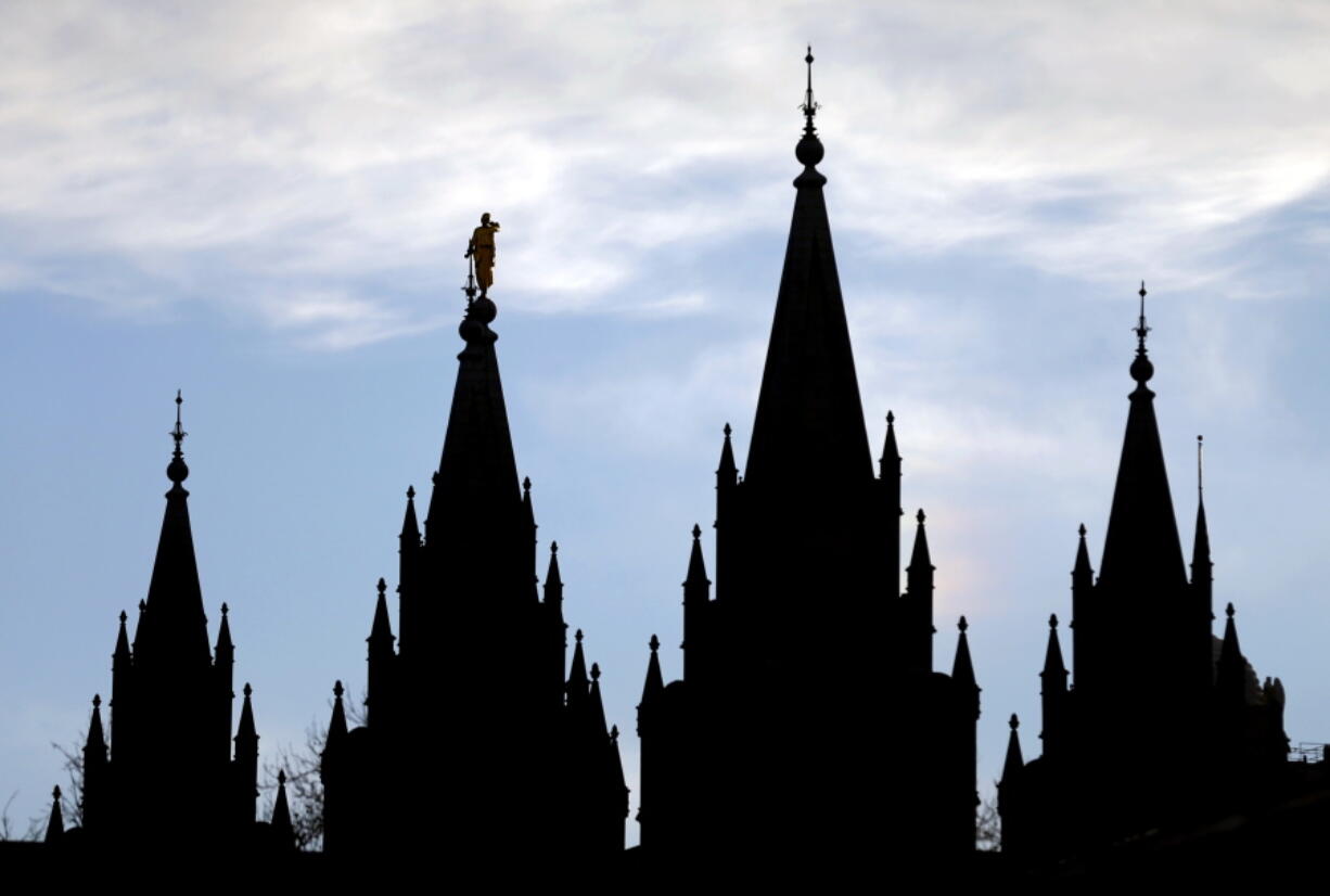 FILE- In this Jan. 3, 2018, file photo, the angel Moroni statue, silhouetted against the sky, sits atop the Salt Lake Temple of The Church of Jesus Christ of Latter-day Saints at Temple Square in Salt Lake City. The Mormon church is renaming websites, social media handles and email addresses as the faith digs in deeper to its push to be known by the religion’s full name and not shorthand names that have been used for generations by church members and others. The Church of Jesus Christ of Latter-day Saints said Tuesday, March 5, 2019, in a news release that websites that used “Mormon” and “LDS” will be phased out.