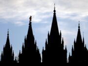 FILE- In this Jan. 3, 2018, file photo, the angel Moroni statue, silhouetted against the sky, sits atop the Salt Lake Temple of The Church of Jesus Christ of Latter-day Saints at Temple Square in Salt Lake City. The Mormon church is renaming websites, social media handles and email addresses as the faith digs in deeper to its push to be known by the religion’s full name and not shorthand names that have been used for generations by church members and others. The Church of Jesus Christ of Latter-day Saints said Tuesday, March 5, 2019, in a news release that websites that used “Mormon” and “LDS” will be phased out.