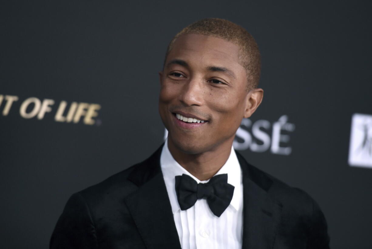 FILE - In this Oct. 11, 2018 file photo, Pharrell Williams arrives at the City of Hope Gala at the Barker Hangar in Santa Monica, Calif. Pharrell is heading home to Virginia Beach to launch a new music and culture festival. The Grammy-winning superstar announced Monday, March 4, 2019, SOMETHING IN THE WATER, a multi-day event he’s calling a “cultural experience” that will debut April 26-28. He will perform on a stage set on the beach; other performers include Missy Elliott, Travis Scott, Migos, Dave Matthews Band, Janelle Monae, SZA and Diplo.