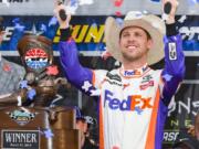 Drive Denny Hamlin celebrates in victory lane after winning a NASCAR Cup auto race at Texas Motor Speedway, Sunday, March 31, 2019, in Fort Worth, Texas.