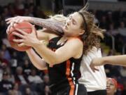 Oregon State guard Mikayla Pivec (0) battles for the ball with Louisville forward Sam Fuehring during the first half of a regional semifinal game in the NCAA women’s college basketball tournament, Friday, March 29, 2019, in Albany, N.Y.