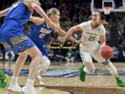 Oregon guard Sabrina Ionescu, right, drives to the basket past South Dakota State guard Tylee Irwin during the first half of a regional semifinal in the NCAA women’s college basketball tournament Friday, March 29, 2019, in Portland, Ore.