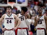 Gonzaga forward Corey Kispert, forward Rui Hachimura and guard Zach Norvell Jr., from left, stand on the court after the team’s loss to Texas Tech in the West Regional final in the NCAA men’s college basketball tournament Saturday, March 30, 2019, in Anaheim, Calif. Texas Tech won 75-69. (AP Photo/Jae C.