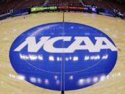 A judge has ruled against the NCAA in a federal antitrust lawsuit, saying football and basketball players should be permitted to receive more compensation from schools but only if the benefits are tied to education.