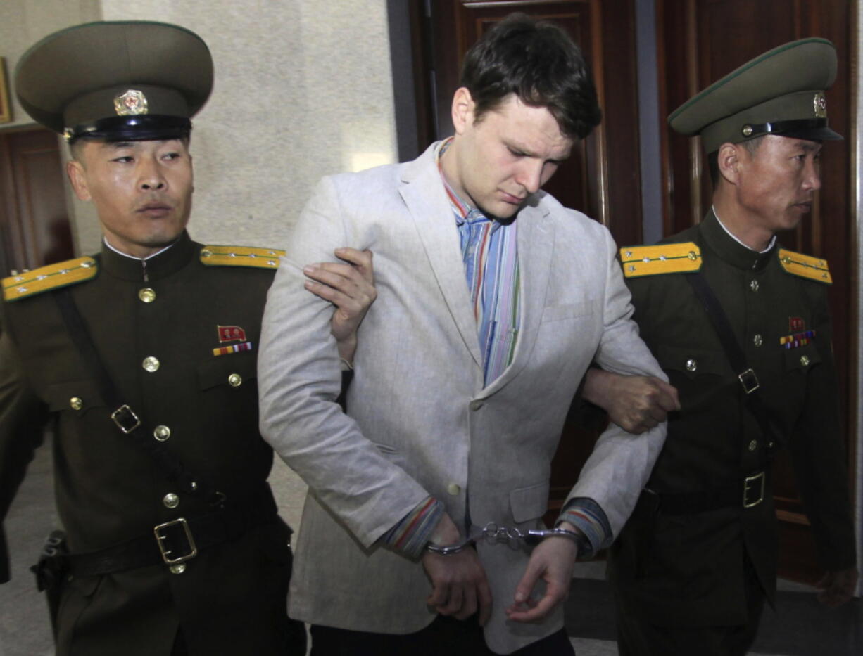 FILE - In this March 16, 2016, file photo, American student Otto Warmbier, center, is escorted at the Supreme Court in Pyongyang, North Korea. President Donald Trump says he doesn’t think North Korean leader Kim Jong Un was involved in the mistreatment of American college student Otto Warmbier, who died after being detained in the North. Trump says of Kim: “He tells me that he didn’t know about it, and I will take him at his word.” The Ohio native was sentenced to 15 years of hard labor in North Korea on suspicion of stealing a propaganda poster. Warmbier died in 2017, shortly after being sent home in a coma.