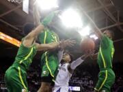 Washington guard David Crisp, second from right, is blocked by Oregon forward Kenny Wooten, second from left, Will Richardson, left, and Louis King, right, during the first half of an NCAA college basketball game, Saturday, March 9, 2019, in Seattle. (AP Photo/Ted S.