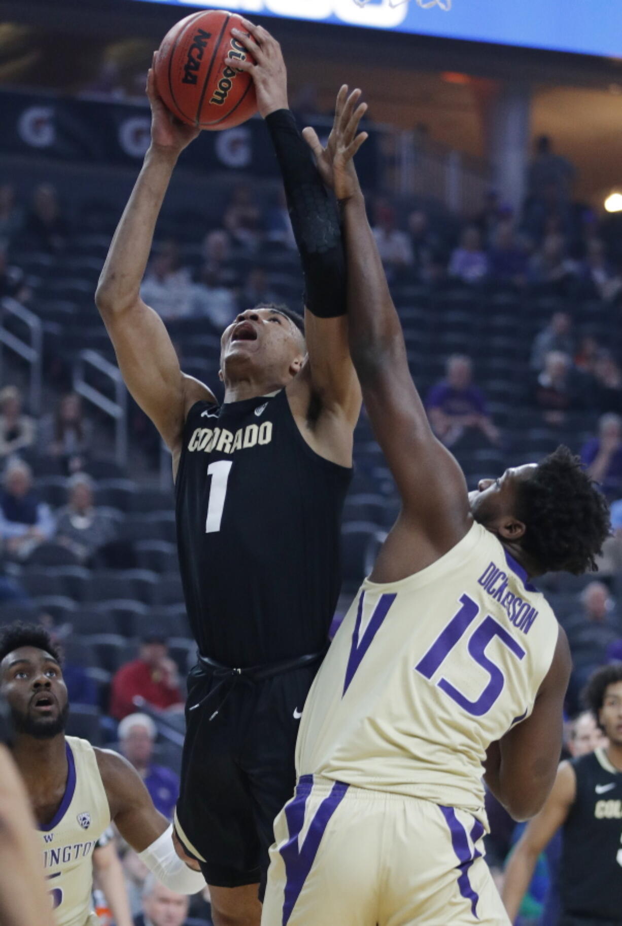 Colorado’s Tyler Bey shoots over Washington’s Noah Dickerson during the first half of an NCAA college basketball game in the semifinals of the Pac-12 men’s tournament Friday, March 15, 2019, in Las Vegas.