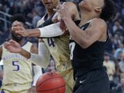 Washington’s Matisse Thybulle, left, fouls Colorado’s Shane Gatling during the first half of an NCAA college basketball game in the semifinals of the Pac-12 men’s tournament Friday, March 15, 2019, in Las Vegas.