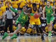 Oregon’s Kenny Wooten (14) tries to steal the ball from Arizona State’s Zylan Cheatham during the first half of an NCAA college basketball game in the semifinals of the Pac-12 men’s tournament Friday, March 15, 2019, in Las Vegas.