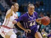 Washington's Missy Peterson drives around Utah's Sarah Porter during the first half of an NCAA college basketball game at the Pac-12 women's tournament Thursday, March 7, 2019, in Las Vegas.