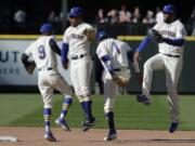 Seattle Mariners’ (from left) Dee Gordon, Mallex Smith, Tim Beckham, and Domingo Santana celebrate at the end of a baseball game against the Boston Red Sox, Sunday, March 31, 2019, in Seattle. The Mariners won 10-8. (AP Photo/Ted S.