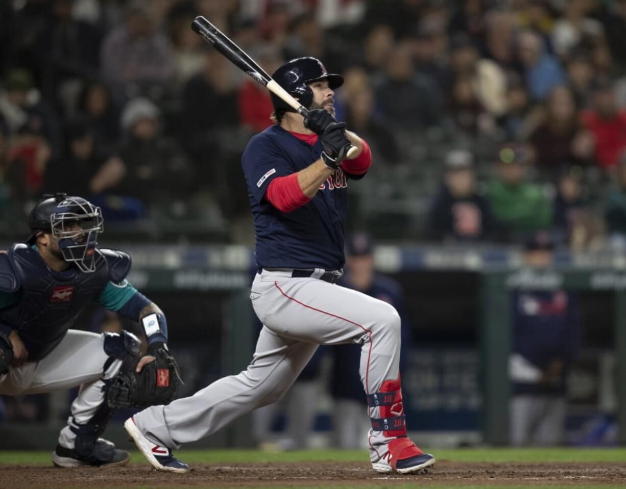 The Boston Red Sox’s Mitch Moreland watches a three-run home run off Seattle Mariners relief pitcher Hunter Strickland during the ninth inning of a baseball game Friday, March 29, 2019, in Seattle.