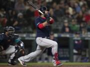 The Boston Red Sox’s Mitch Moreland watches a three-run home run off Seattle Mariners relief pitcher Hunter Strickland during the ninth inning of a baseball game Friday, March 29, 2019, in Seattle.