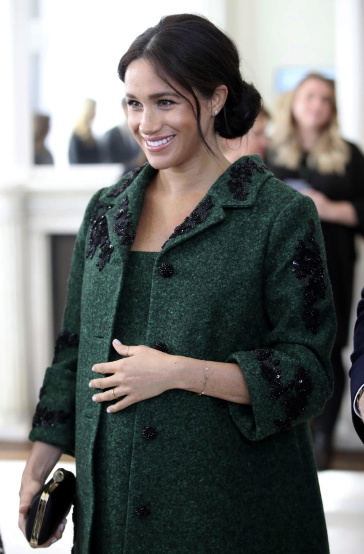 FILE - In this March 11, 2019 file photo, Britain’s Meghan, Duchess of Sussex arrive for the Commonwealth Day Youth Event with Prince Harry, at Canada House in London. With another royal baby on the horizon, the debate over postpartum perfection is alive and well. As it stands, we don’t know whether Meghan Markle will follow in the footsteps of Kate Middleton when it comes to that magical perfection, but we have an inkling she’ll at least slap on some makeup when she introduces the latest royal to the world next month.