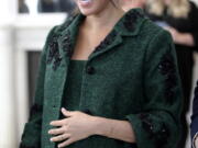 FILE - In this March 11, 2019 file photo, Britain’s Meghan, Duchess of Sussex arrive for the Commonwealth Day Youth Event with Prince Harry, at Canada House in London. With another royal baby on the horizon, the debate over postpartum perfection is alive and well. As it stands, we don’t know whether Meghan Markle will follow in the footsteps of Kate Middleton when it comes to that magical perfection, but we have an inkling she’ll at least slap on some makeup when she introduces the latest royal to the world next month.