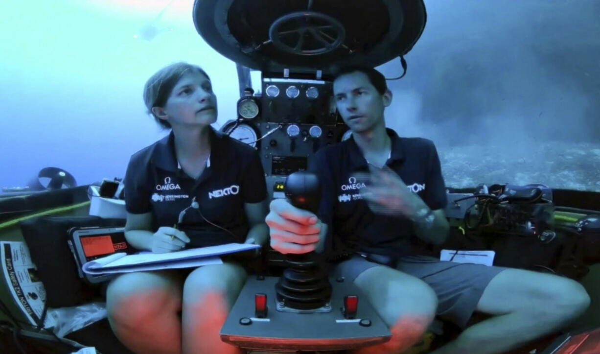 An image taken from video issued by Nekton shows Lucy Woodall, Nekton Mission principle scientist, left, alongside pilot Randy Holt inside a submersible 60 metres below surface of Indian Ocean during a descent into the Indian Ocean off Alphonse Atoll near the Seychelles, Tuesday March 12, 2019. Members of the British-led Nekton research team boarded two submersible vessels and descended into the waters off the Seychelles on Tuesday, marking a defining moment in their mission to document changes to the Indian Ocean. The submersibles will be battling strong undersea currents and potentially challenging weather conditions as they survey the side of an undersea mountain off Alphonse Atoll.