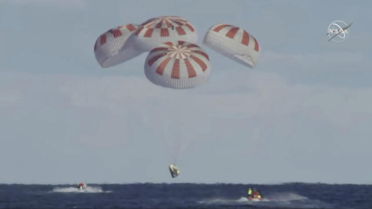 This image provided by NASA shows SpaceX’s Dragon capsule carrying a test dummy splashed down into the Atlantic ocean off the Florida coast, Friday, March 8, 2019. It marks the first time in 50 years that a capsule designed for astronauts returned from space by plopping into the Atlantic.