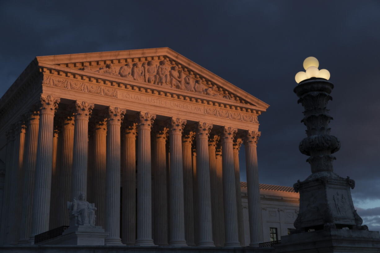 In this Jan. 24, 2019 file photo, the Supreme Court is seen at sunset in Washington, Thursday, Jan. 24, 2019. The Supreme Court is rejecting an appeal from a Nebraska county that has to pay a $28 million court judgment to six people wrongfully convicted for a 1985 slaying. The justices on Monday turned away Gage county’s last-ditch effort to avoid the hefty judgment. The federal appeals court in St. Louis had previously upheld the jury verdict against Gage county, saying it was justified because of egregious law enforcement conduct. (AP Photo/J.