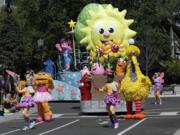 In this Tuesday, March 26, 2019 photo, floats, performers and characters including Big Bird take part in a parade during a preview day at SeaWorld Orlando opening of Sesame Street land in Orlando, Fla., an addition to central Florida’s theme park landscape aimed at young families.