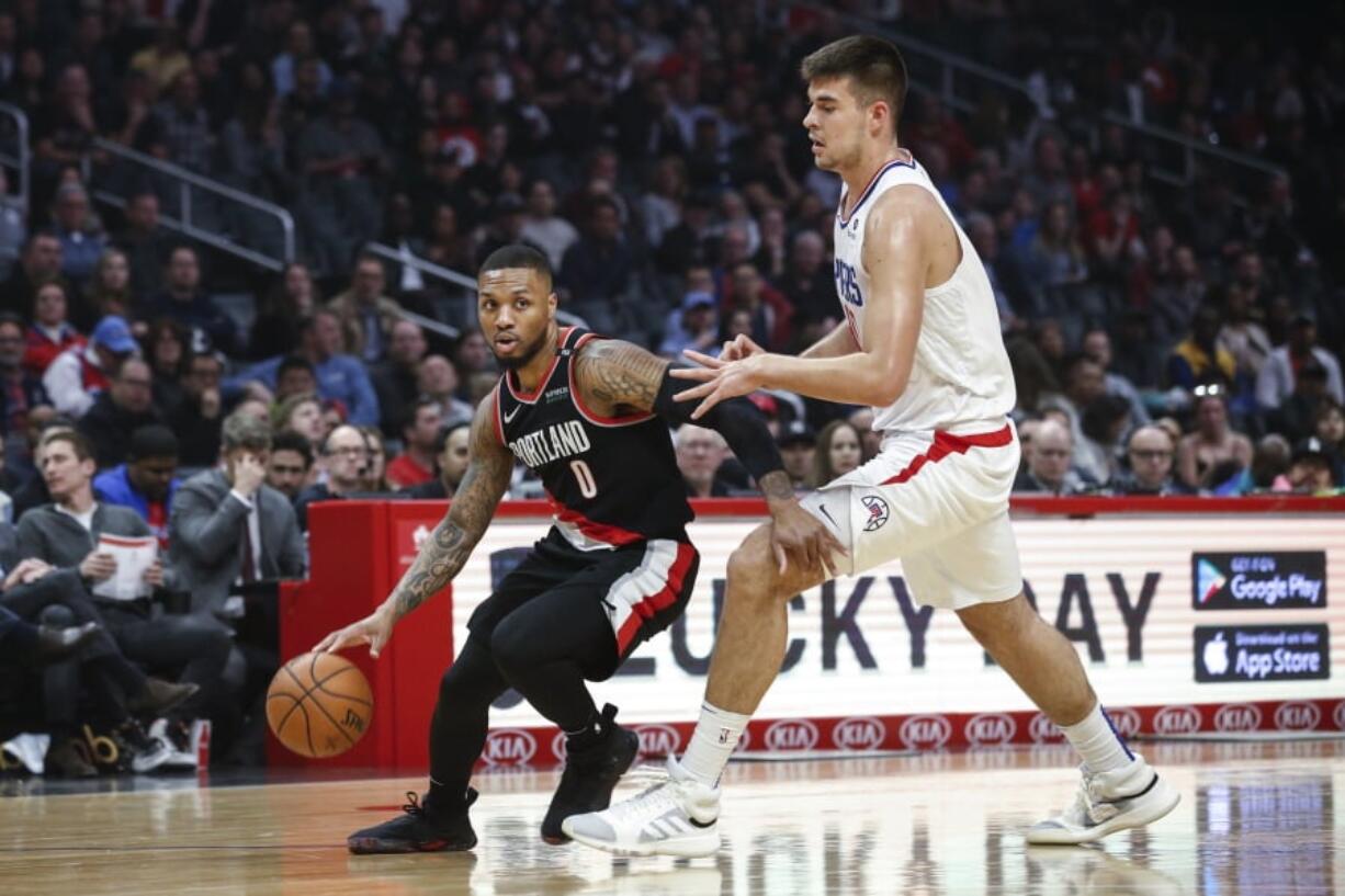 Portland Trail Blazers’ Damian Lillard, left, drives against Los Angeles Clippers’ Ivica Zubac during the first half of an NBA basketball game Tuesday, March 12, 2019, in Los Angeles. (AP Photo/Ringo H.W.