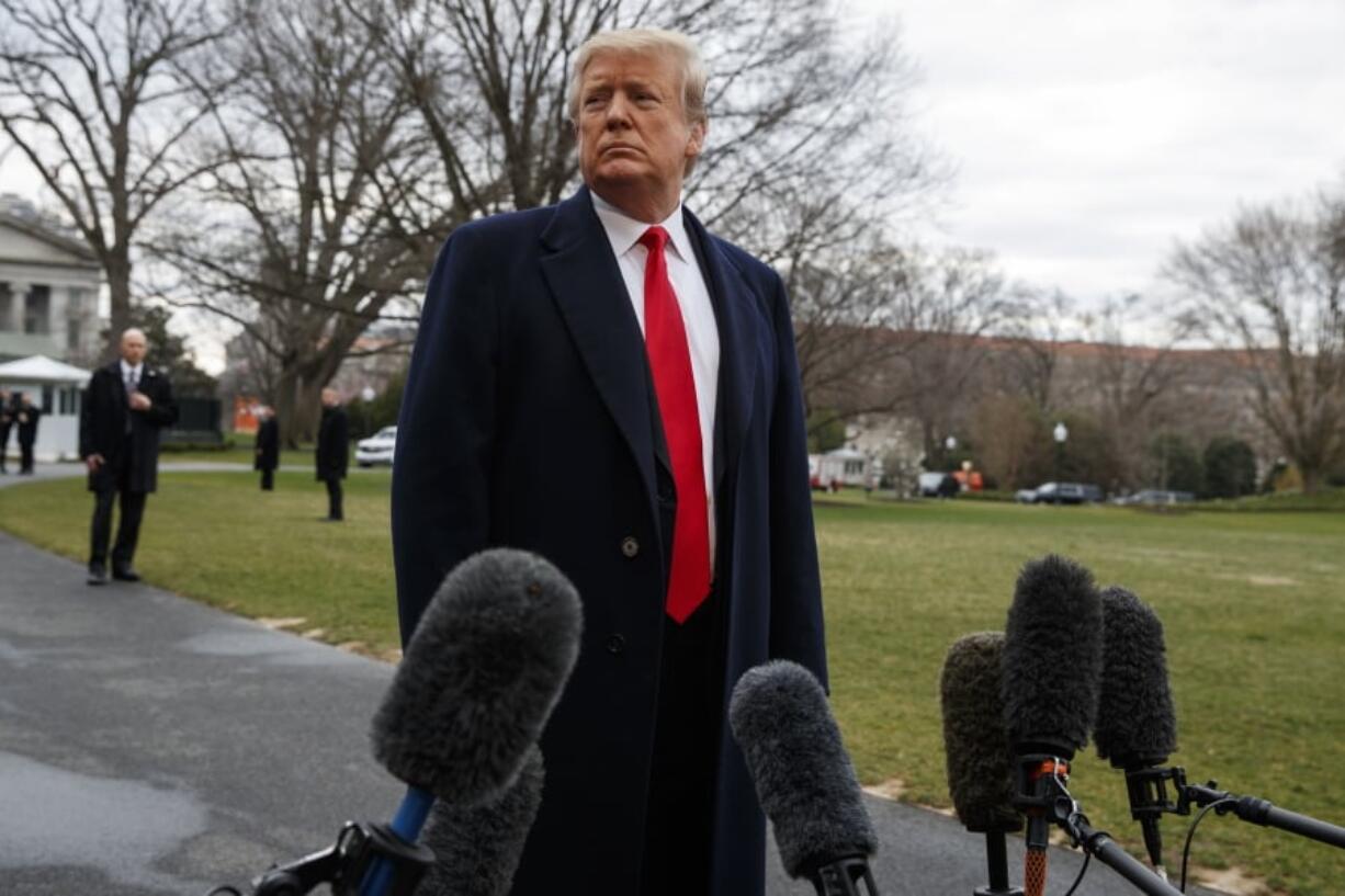 President Donald Trump listens to a question as he speaks with reporters before boarding Marine One on the South Lawn of the White House, Friday, March 22, 2019, in Washington.