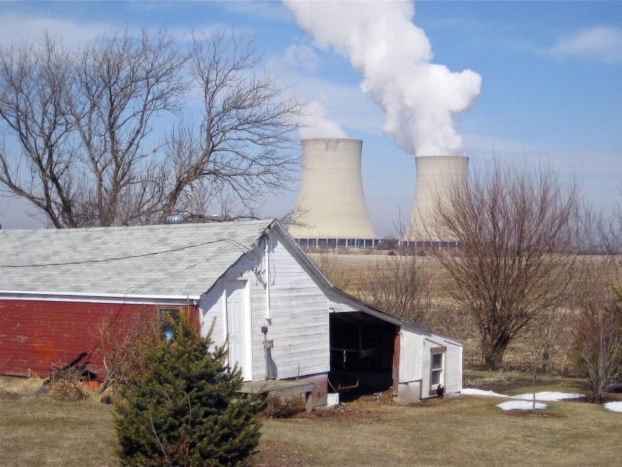 FILE - In this March 16, 2011, file photo, steam escapes from Exelon Corp.’s nuclear plant in Byron, Ill. The nuclear power industry is pushing the Nuclear Regulatory Commission to cut back on inspections at nuclear power plants and throttle back what it tells the public about plant problems.