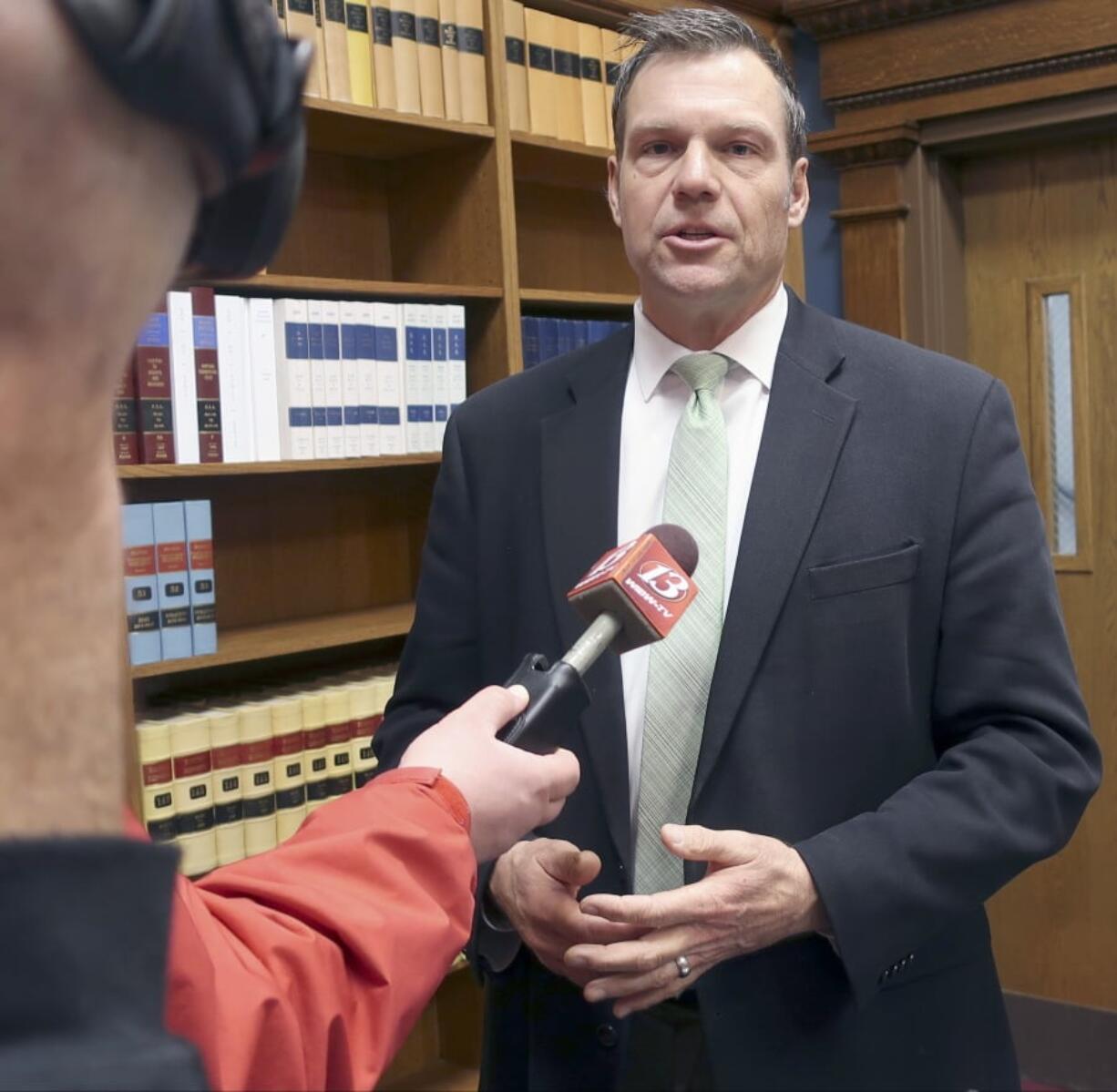 FILE - In this Nov. 30, 2018 file photo, then Kansas Secretary of State Kris Kobach responds to questions from reporters in Topeka, Kan. An appeals court in Salt Lake City, will consider Monday, March 18, 2019, the constitutionality of a struck down Kansas statute that had required people to provide documents proving U.S. citizenship before they could register to vote.