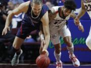 St. Mary’s Jock Perry, left, and Gonzaga’s Josh Perkins scramble for the ball during the first half of an NCAA college basketball game for the West Coast Conference men’s tournament title, Tuesday, March 12, 2019, in Las Vegas.