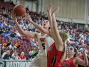 Washougal's Beyonce Bea (5), scores two transition points around Clarkston's Erika Pickett (14), during the WIAA 2A girls state tournament on Friday, Mar. 1, 2019, at the Yakima Valley SunDome.