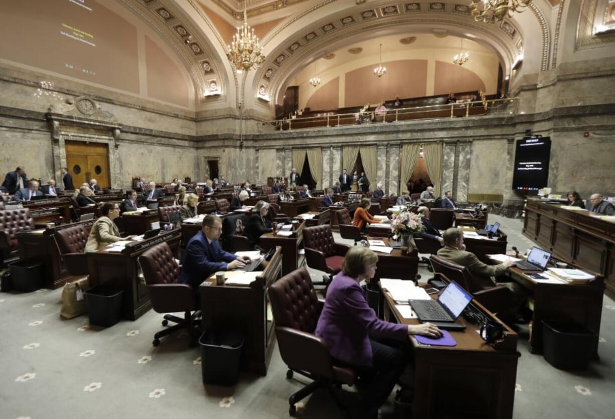 Senators work on the Senate floor March 15 at the Capitol in Olympia. Washington lawmakers are now more than halfway through a 105-day legislative session. Ted S.