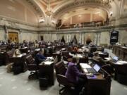 Senators work on the Senate floor March 15 at the Capitol in Olympia. Washington lawmakers are now more than halfway through a 105-day legislative session. Ted S.