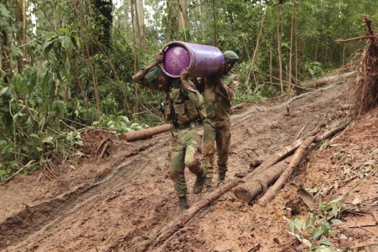 Soldiers carry supplies to areas affected by Cyclone Idai in Chimanimani, about 600 kilometers southeast of Harare, Zimbabwe, Monday, March 18, 2019.